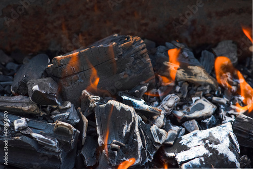 Bonfire embers. BBQ coals with fire. Close-up of the combustion process of wood, charcoal for barbecue