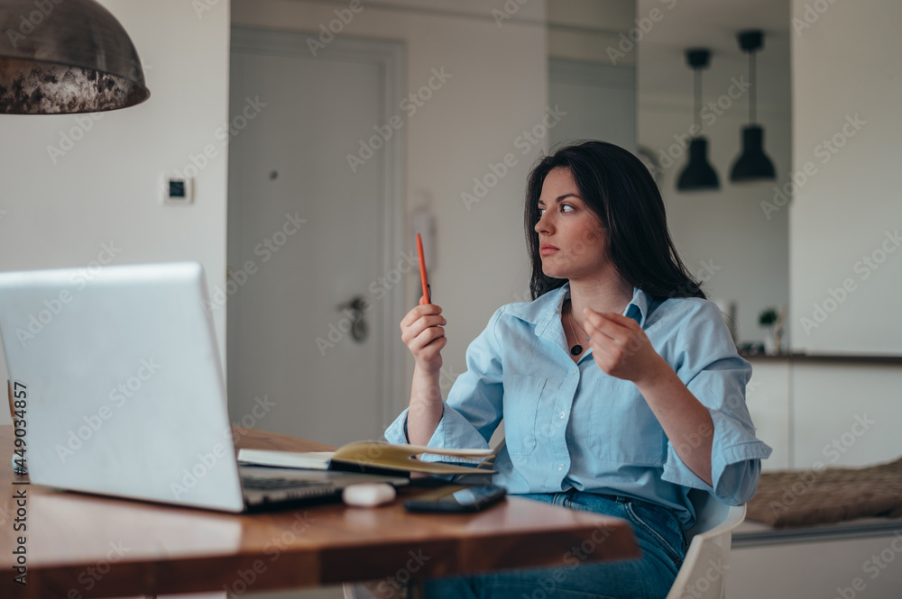 Businesswoman working in her office while using a laptop Businesswoman working in her office while using a laptop