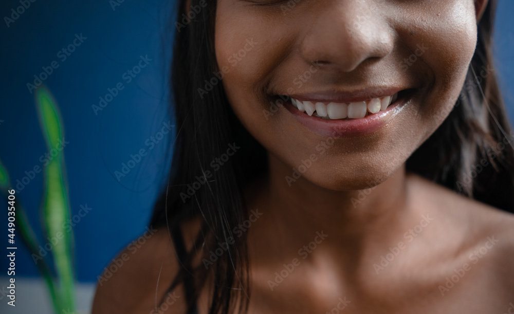 Extreme close up of a cheerful dark-skinned girl in a beautiful smile with healthy white teeth and sweet pink lips Extreme close up of a cheerful dark-skinned girl in a beautiful smile with healthy white teeth and sweet pink lips