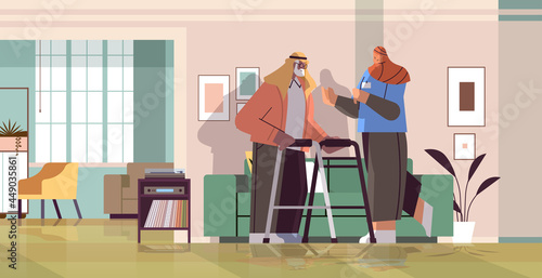 friendly nurse or volunteer supporting arab elderly man with walkers home care services healthcare
