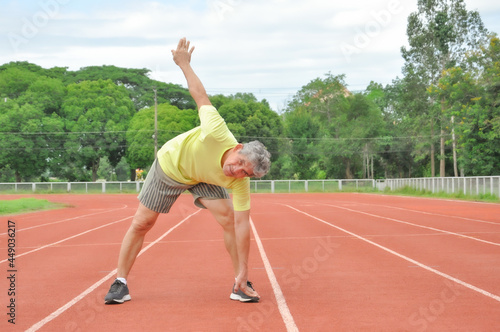an old man warming up exercise before running or jogging, concept health care in elderly people © Verin