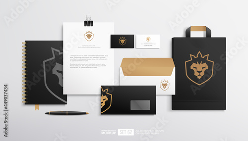 Business stationery branding mockup set with concept of lion head shield logo design. Brand identity set of blank, shopping bag, yoga flyer, business card and envelope. Black stationery