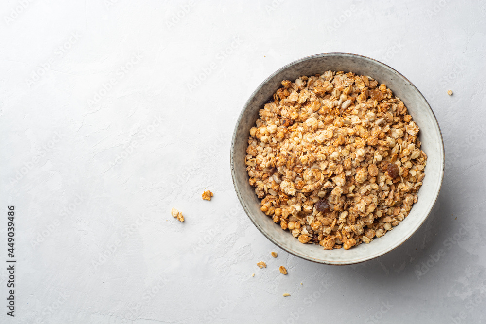 Granola cereal in bowl on concrete background Granola cereal in bowl on concrete background