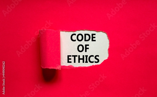 Code of ethics symbol. Words 'Code of ethics' appearing behind torn purple paper. Beautiful purple background. Business, code of ethics concept, copy space.