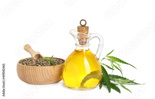 Hemp oil, fresh leaves and seeds on white background