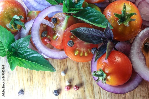 tomatoes onion basil and seasonings on a wooden board, salad mix, vegetable mix