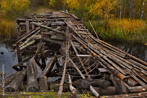 Fototapeta Naklejka Na Ścianę i Meble -  Russia. Republic of Karelia. A destroyed wooden automobile bridge on the North-Eastern shore of Lake Onega, partially restored for pedestrians.