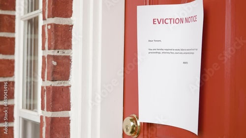 eviction notice taped to a front door of a home photo