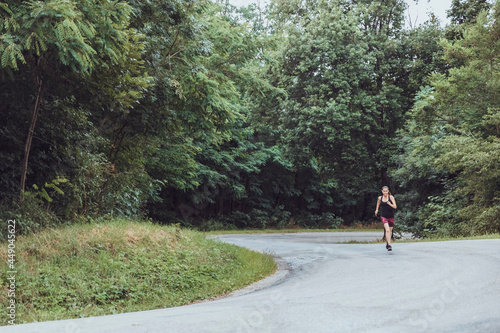 Woman running in the woods. Female runner. Run