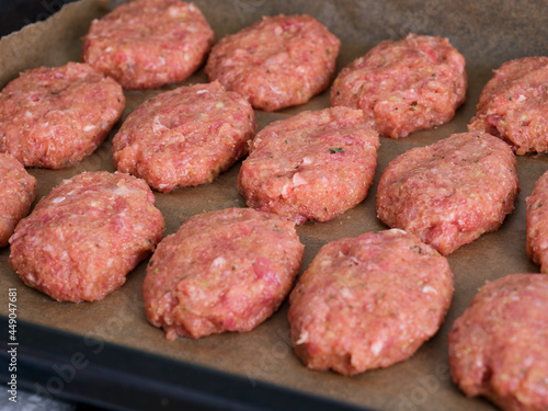 Baking tray with a raw cutlets ready to cook