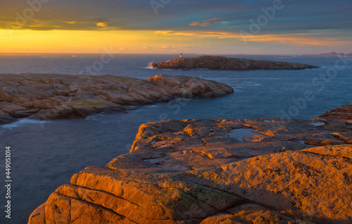 Beautiful view of the rocks and the hills surrounding the waters during the sunset photo