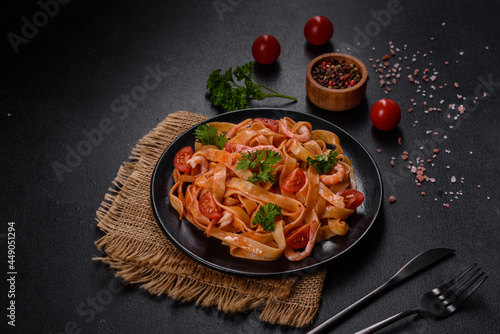 Fettuccine pasta with shrimp, cherry tomatoes, sauce, spices and herbs