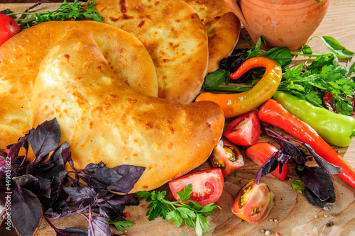 Traditional Georgian adjara khachapuri and Kolkh khachapuri on the table. Assorted Georgean bread. photo