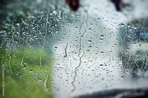 Photography Abstract capture of Natural water drop on the Window glass from inside the Car with condensation during rainy day traveling on drive by road