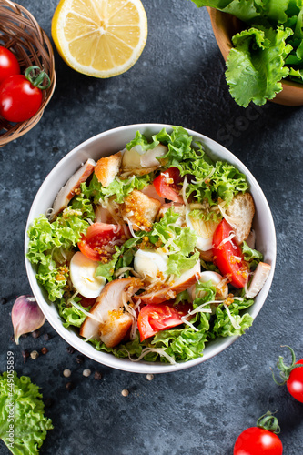 Classic caesar salad with chicken fillet and parmesan cheese. Chicken Caesar Salad. Top view, copy space.