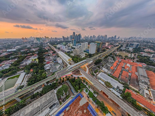 Aerial view of articulated city buses arriving and leaving at bus station near main railway station MRT line at Kebayoran Baru. Jakarta, Indonesia, Agustus 5, 2021