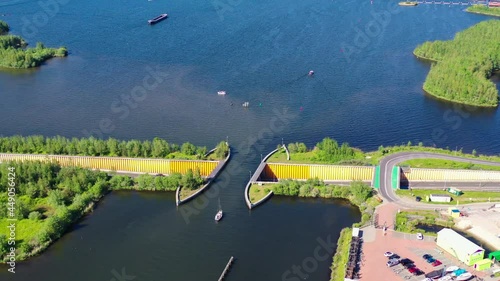 Aquaduct Veluwemeer, Nederland. Aerial view from the drone. A sailboat sails through the aqueduct on the lake above the highway. High quality 4k footage