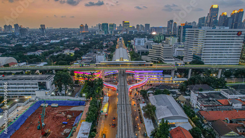 Aerial view of articulated city buses arriving and leaving at bus station near main railway station MRT line at Kebayoran Baru. Jakarta, Indonesia, Agustus 5, 2021 photo