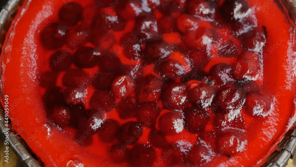 top view of red cheesecake made from fresh berries and milk curd. Rotate dessert. Brown wooden background. Close-up. Excellent breakfast top view of red cheesecake made from fresh berries and milk curd. Rotate dessert. Brown wooden background. Close-up. Excellent breakfast