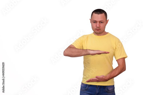 a serious 40-year-old man shows a large size sign between his hands. a symbol of measurement. copy space template over white background. isolated