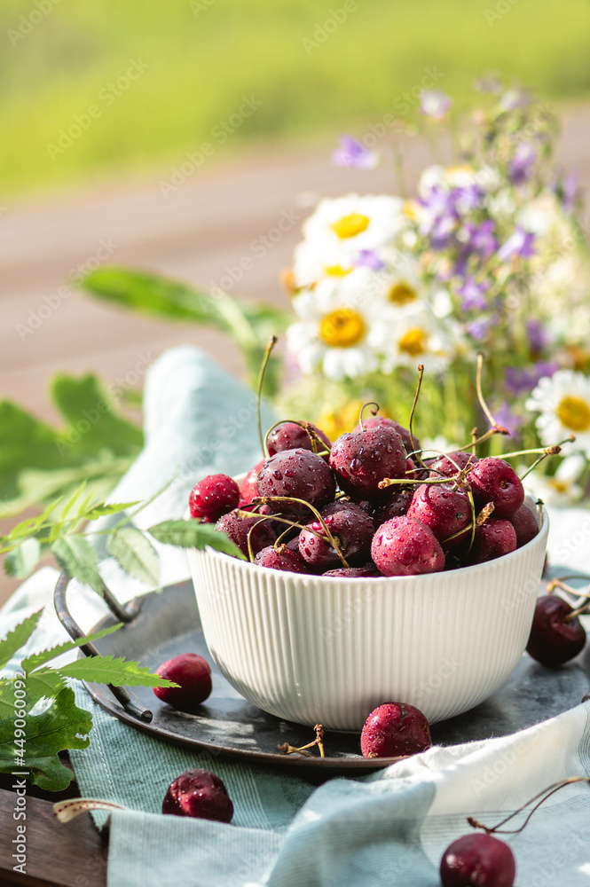 Delicious ripe sweet cherries on summer terrace Delicious ripe sweet cherries on summer terrace