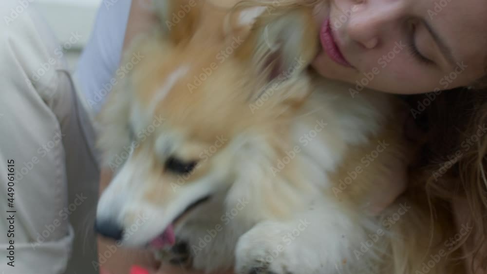 Happy mature female pet owner relaxing and embracing. Young woman hugging dog in the city in summer Happy mature female pet owner relaxing and embracing. Young woman hugging dog in the city in summer