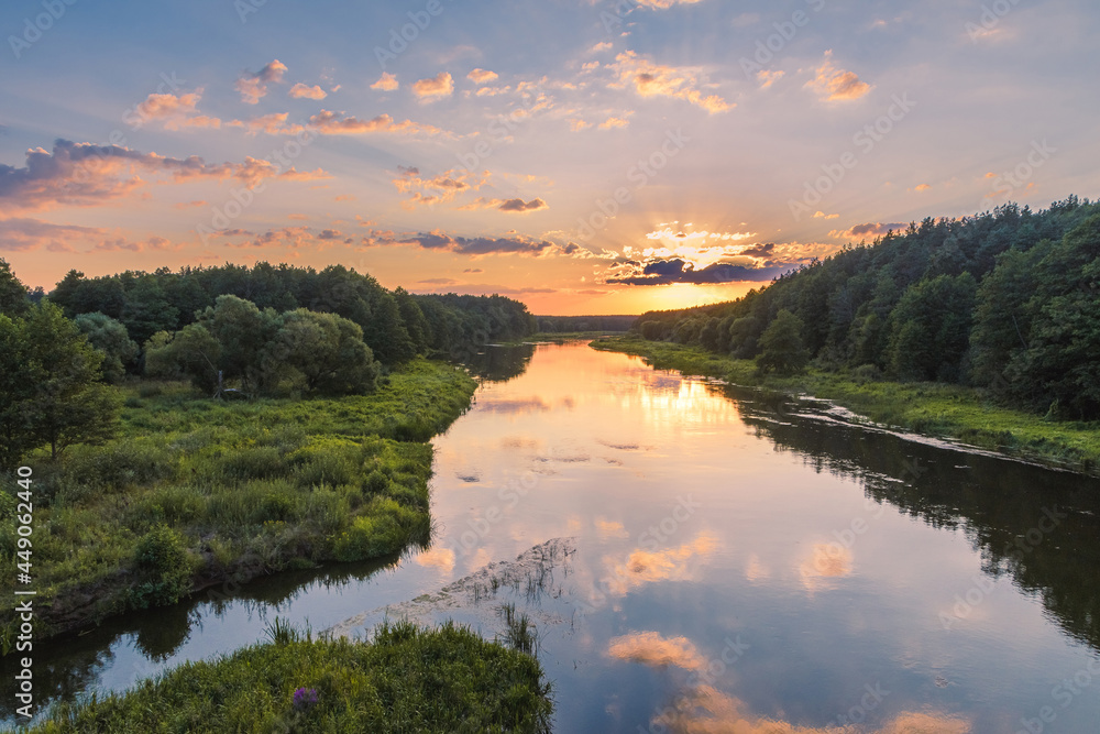 The view of the Viliya river in the forest. The sunset over the river. Nature landscape in Belarus