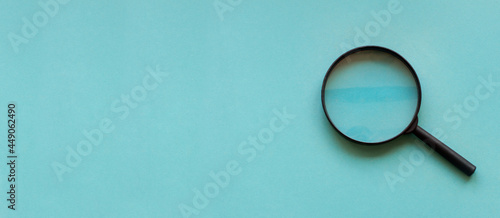 magnifying glass magnifier loupe search symbol on blue background with copy space