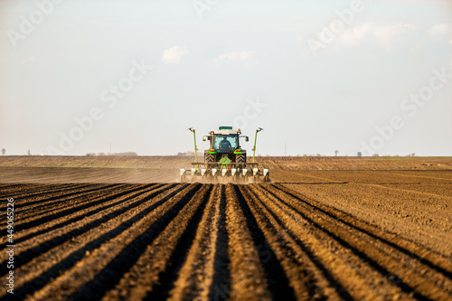 Fotografie Farmer seeding, sowing crops at field