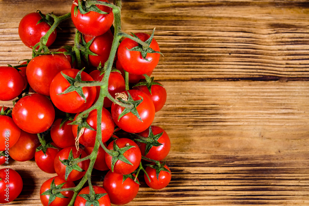 Heap of small cherry tomatoes on wooden table. Top view Heap of small cherry tomatoes on wooden table. Top view