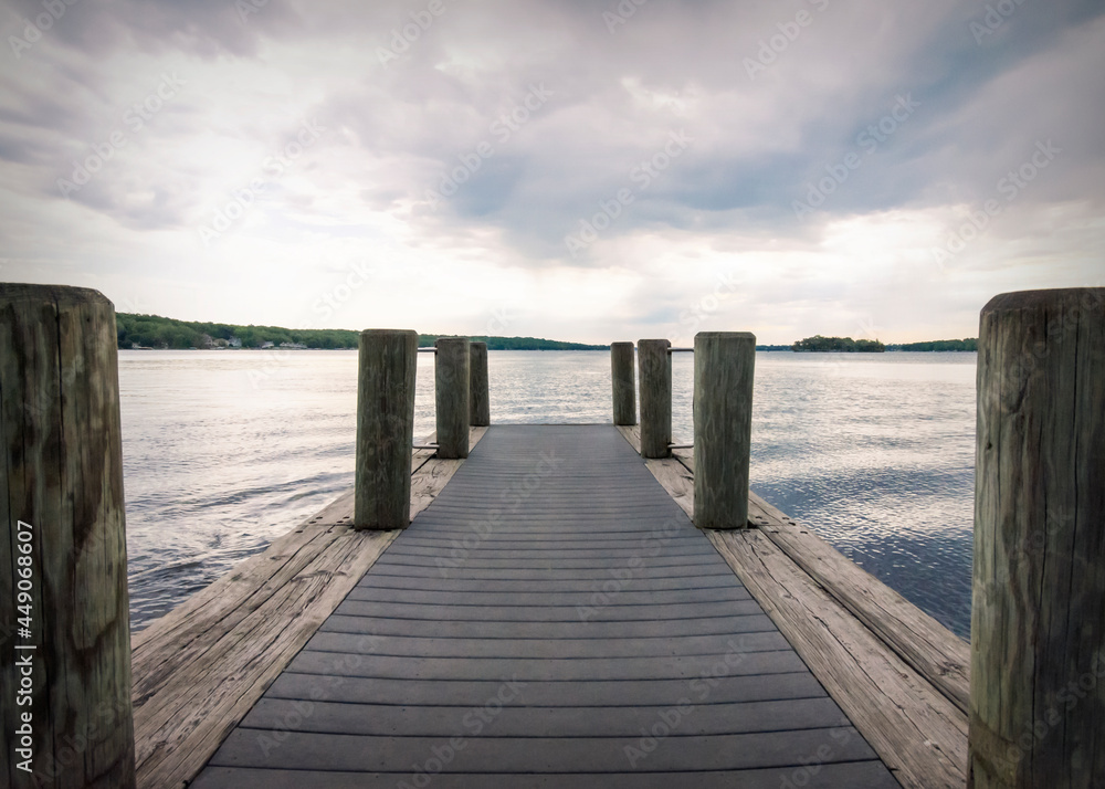 Looking down a boat pier on a cloudy morning on Pewaukee Lake in Waukesha County, Wisconsin.