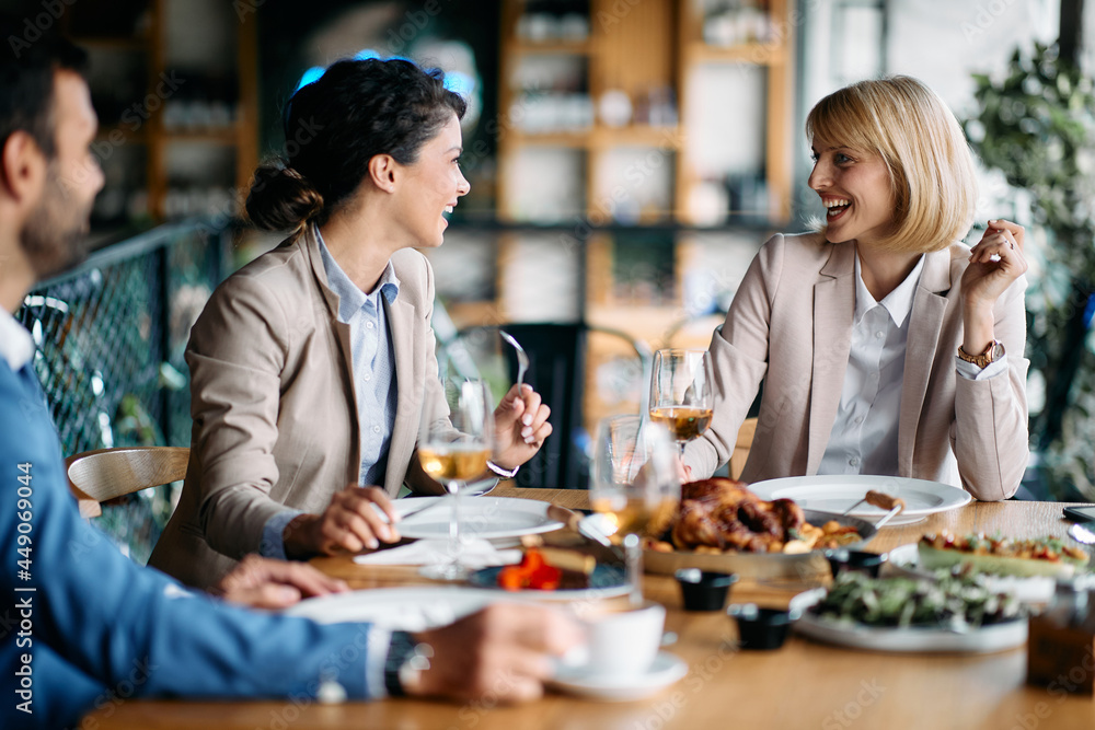 Group of happy entrepreneurs talk while enjoying in business lunch in restaurant. Group of happy entrepreneurs talk while enjoying in business lunch in restaurant.