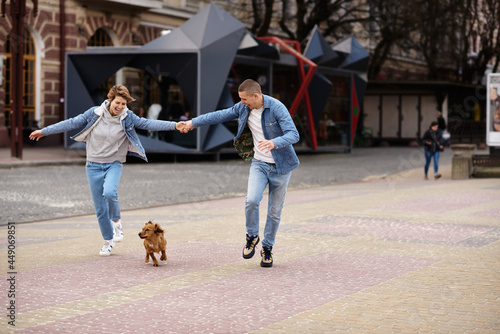 young family walking a dog