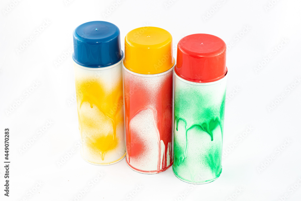 Three Colored Spray Paint Cans on White Background. Graffiti's Inventory - Close-Up Shot Three Colored Spray Paint Cans on White Background. Graffiti's Inventory - Close-Up Shot