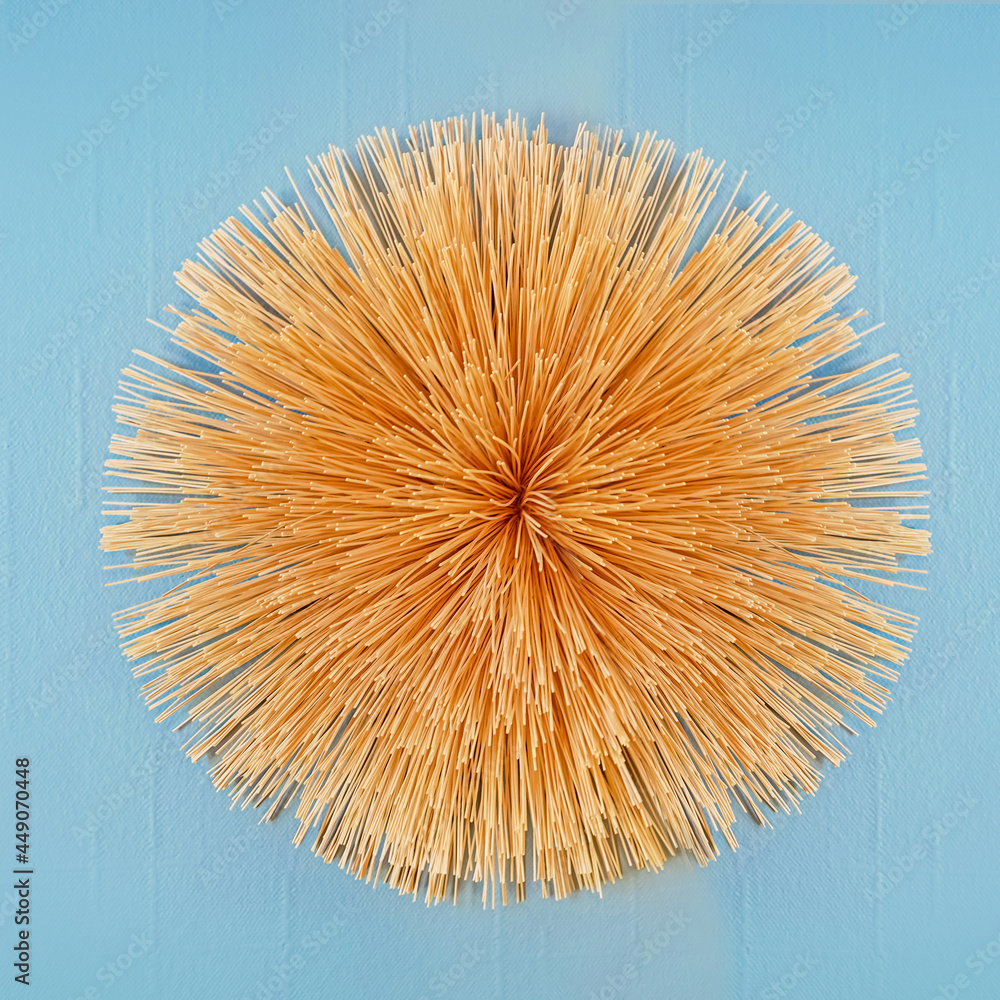 Dry straw wreath on a blue background. A decorative element for decorating your home with your own hands.