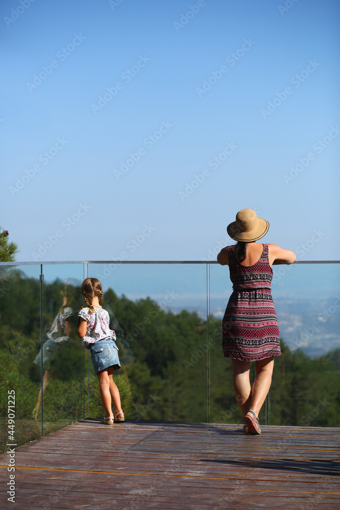Mother and daughter standing on the observation deck and enjoying the view of Troodos mountains, Cyprus Mother and daughter standing on the observation deck and enjoying the view of Troodos mountains, Cyprus
