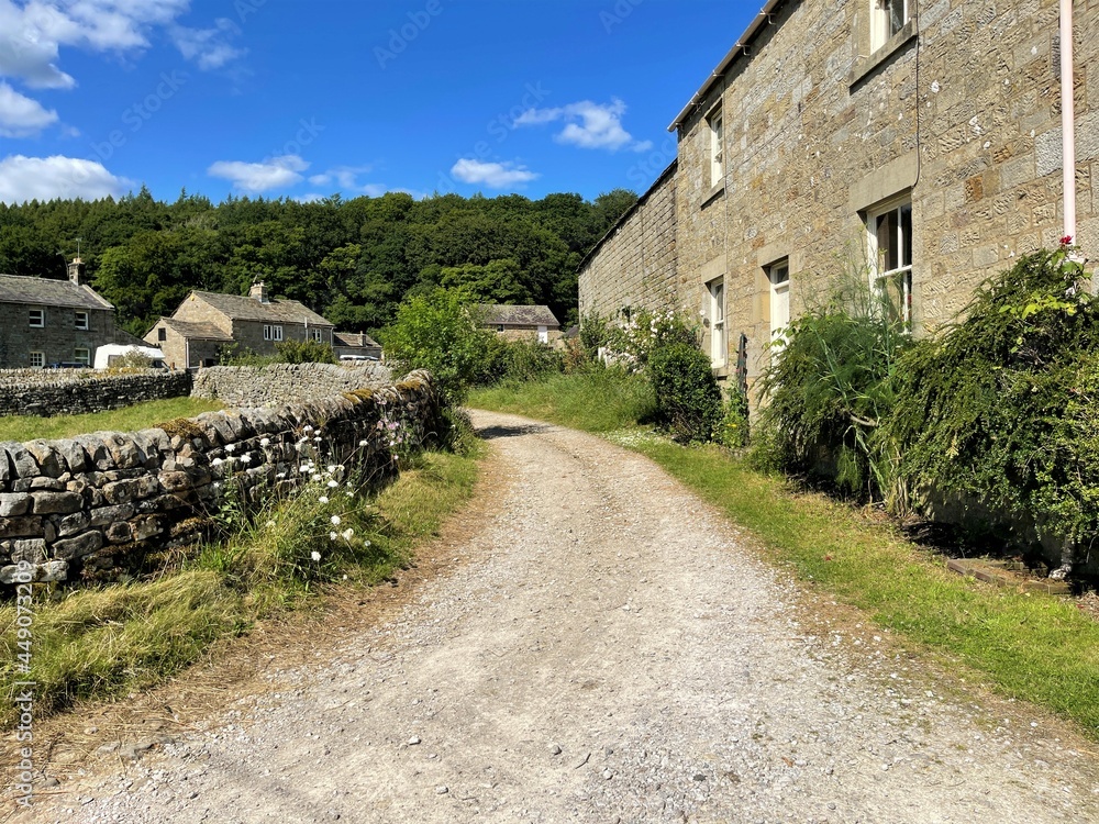 Back Lane, with dry stone walls, cottages, and trees near, Pateley Bridge, Harrogate, UK