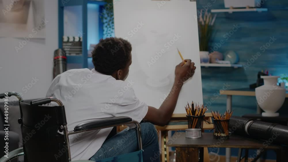 Black invalid person sitting in artwork space drawing vase using white canvas and pencil from table. Disabled african american artist in wheelchair creating design as artistic hobby Black invalid person sitting in artwork space drawing vase using white canvas and pencil from table. Disabled african american artist in wheelchair creating design as artistic hobby