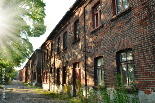 A row of old red brick houses at Ksiezy Mlyn in Lodz photo