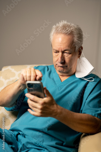 Photo of a doctor or male nurse using a cellular smartphone