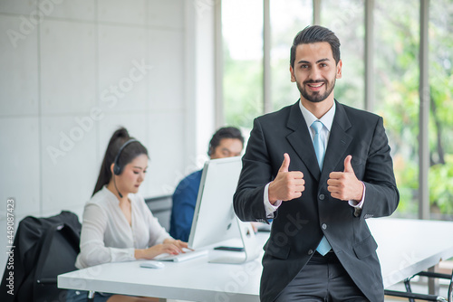 Boss or manager stand and show thump up happy ,background customer service or telemarketing