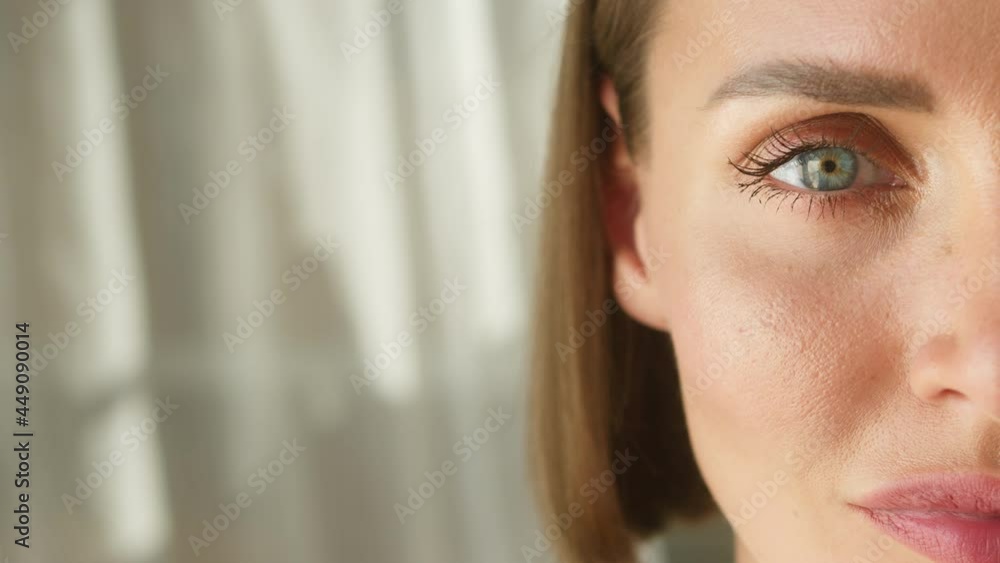 Young woman face close-up, half-face portrait of female model with braces on teeth and beautiful blue eyes looking in camera. Positive glance of businesswoman person. Young woman face close-up, half-face portrait of female model with braces on teeth and beautiful blue eyes looking in camera. Positive glance of businesswoman person.