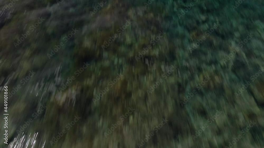 flight over crystal clear water with rocks inside. The view is tilting up toward the horizon - drone filght flight over crystal clear water with rocks inside. The view is tilting up toward the horizon - drone filght