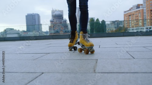 Woman legs making steps on rollerblades outside. Roller skater riding outdoor. photo