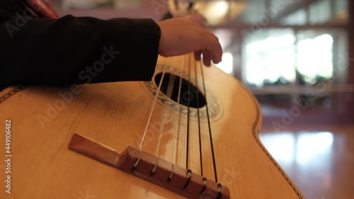 Close up of mariachi charro playing guitar
