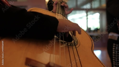 Slow-motion close up of mariachi guitar