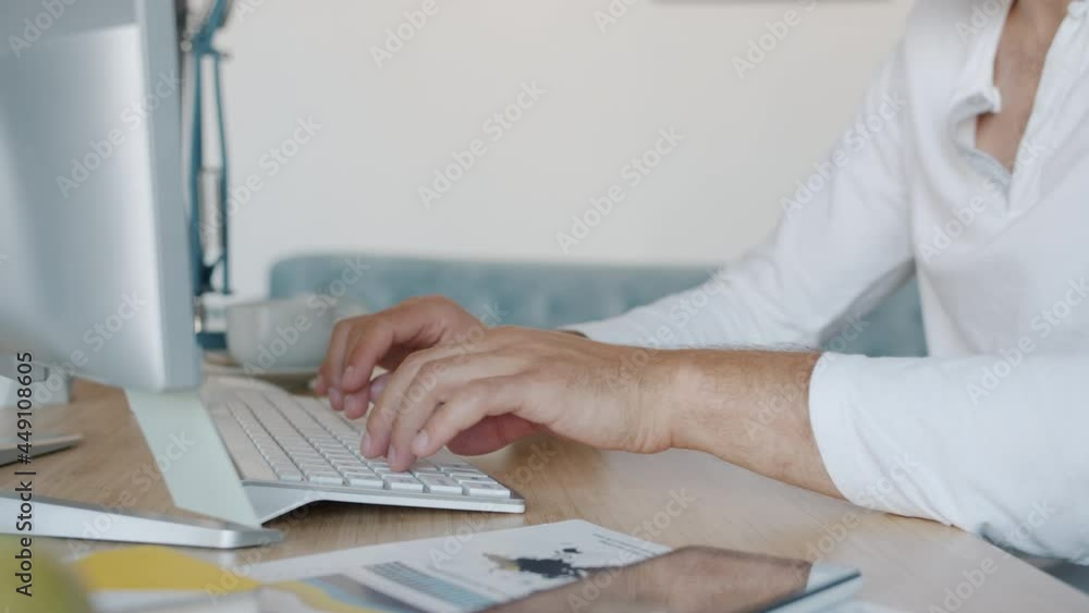 Slow motion close-up of freelancer's hands typing with keyboard and taking coffee cup while man is working indoors at home. Technology and job concept. Slow motion close-up of freelancer's hands typing with keyboard and taking coffee cup while man is working indoors at home. Technology and job concept.