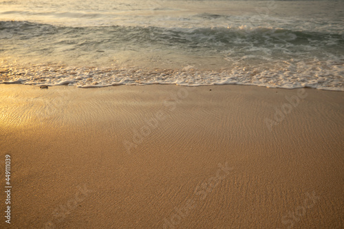 Scenic seascape. Milky foam waves at the beach. Sunset time. Waterscape for background. Selected soft art focus. Sunlight reflection on the water and sand. Balangan beach  Bali  Indonesia