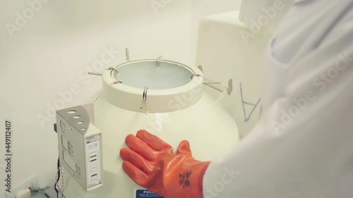 Scientist Opening Tank with Liquid Nitrogen at the Lab. Close Up. 4K Resolution. photo