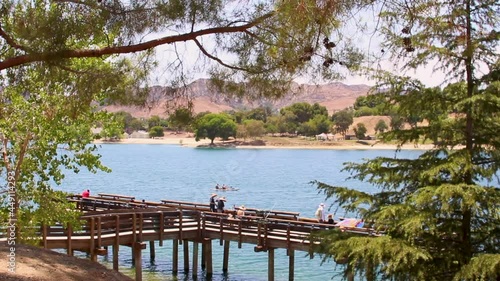 A daytime shot at of people fishing off of a dock at Lake Castaic in California USA, near Six Flags CA. photo